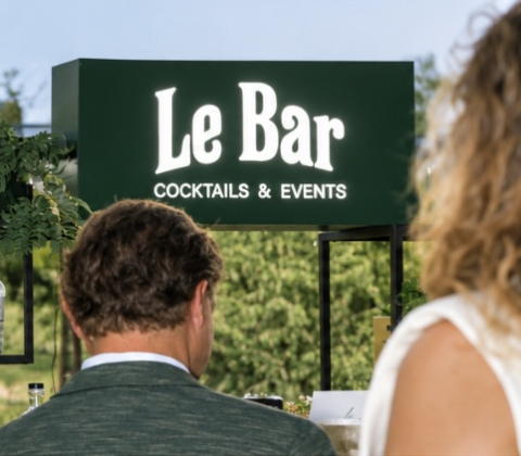 Gasten van achteren gefotografeerd terwijl ze bij de bar van Le Bar staan